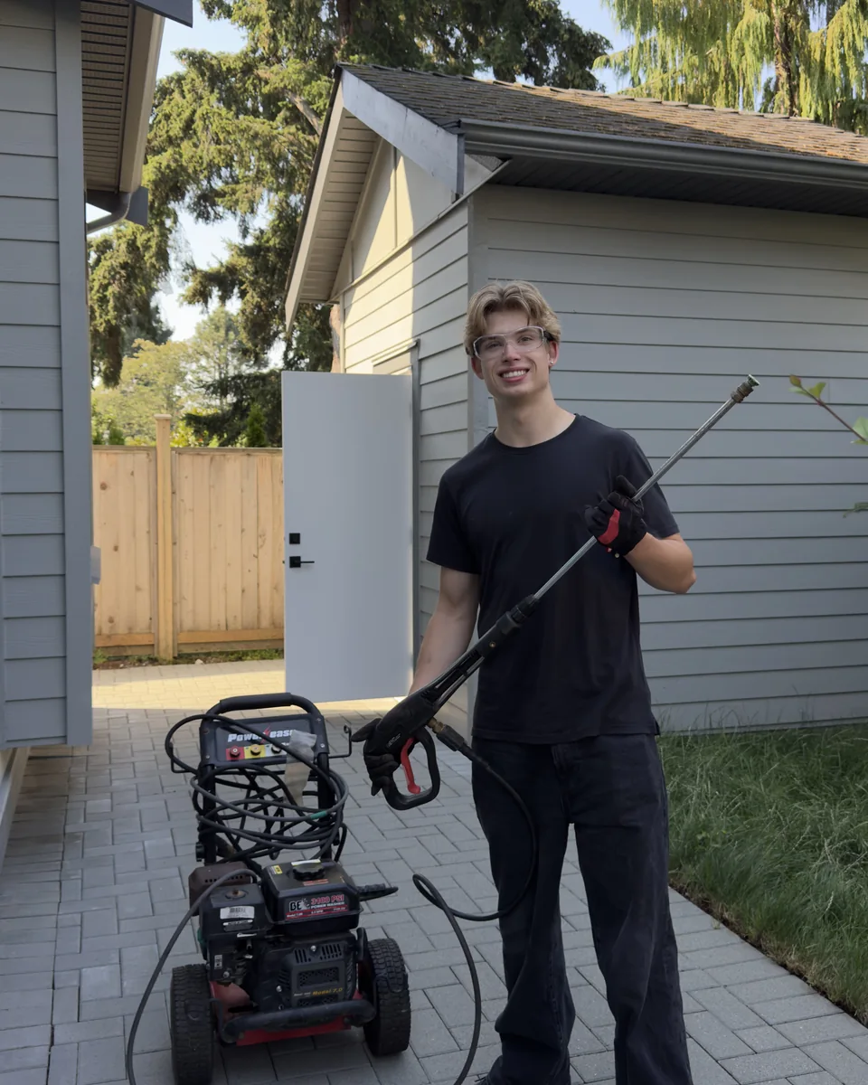 West Wave Wash field technician standing with pressure-washing equipment